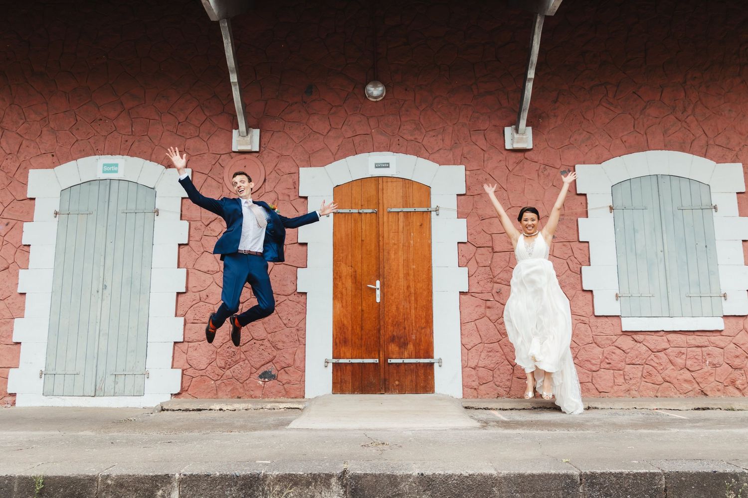 Sequential photos along a pink wall with white shuttered windows and doors creating a playful composition.