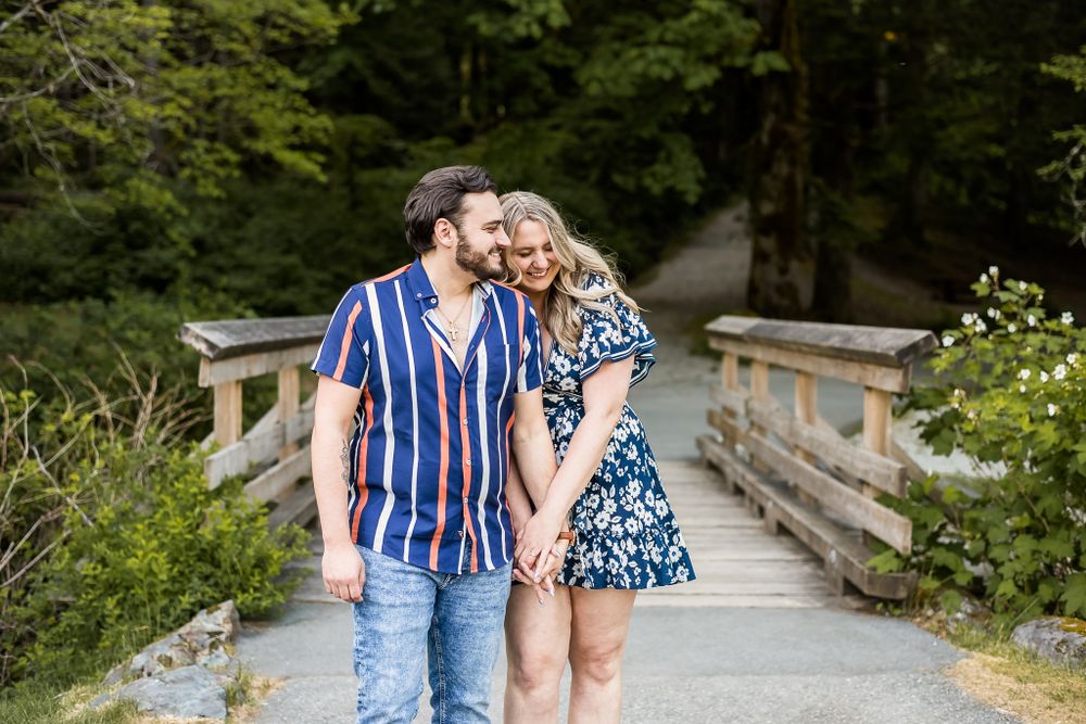 A woman snuggles in close during a walk outside with her fiance. Golden Ears Provincial Park in Maple Ridge, BC.