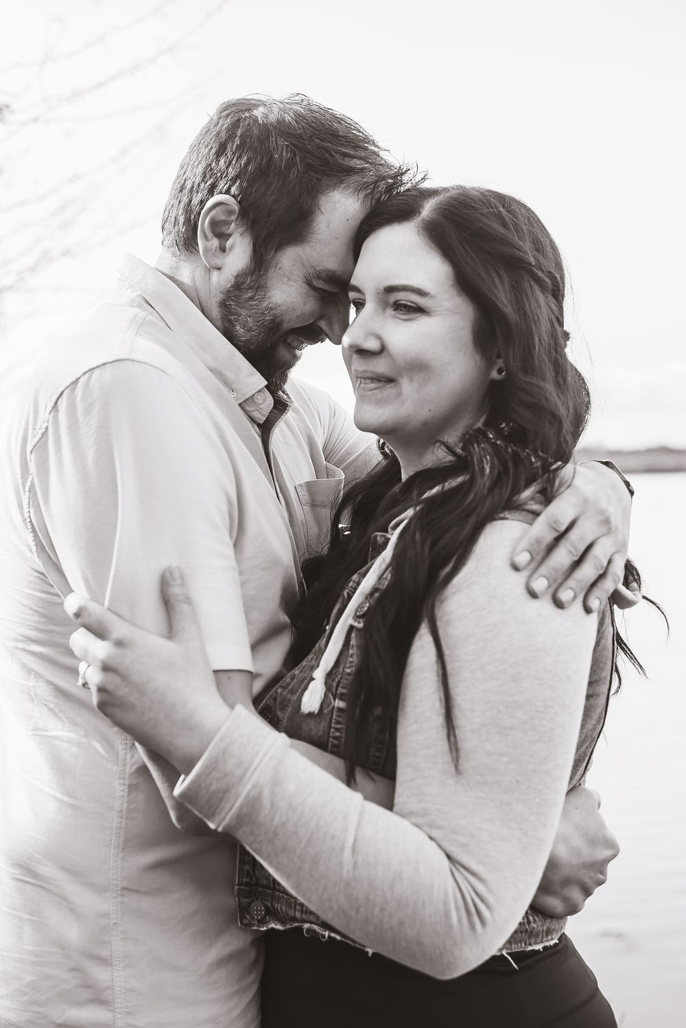 A black and white image of a couple embracing each other on the shores of the Nikomekl River.