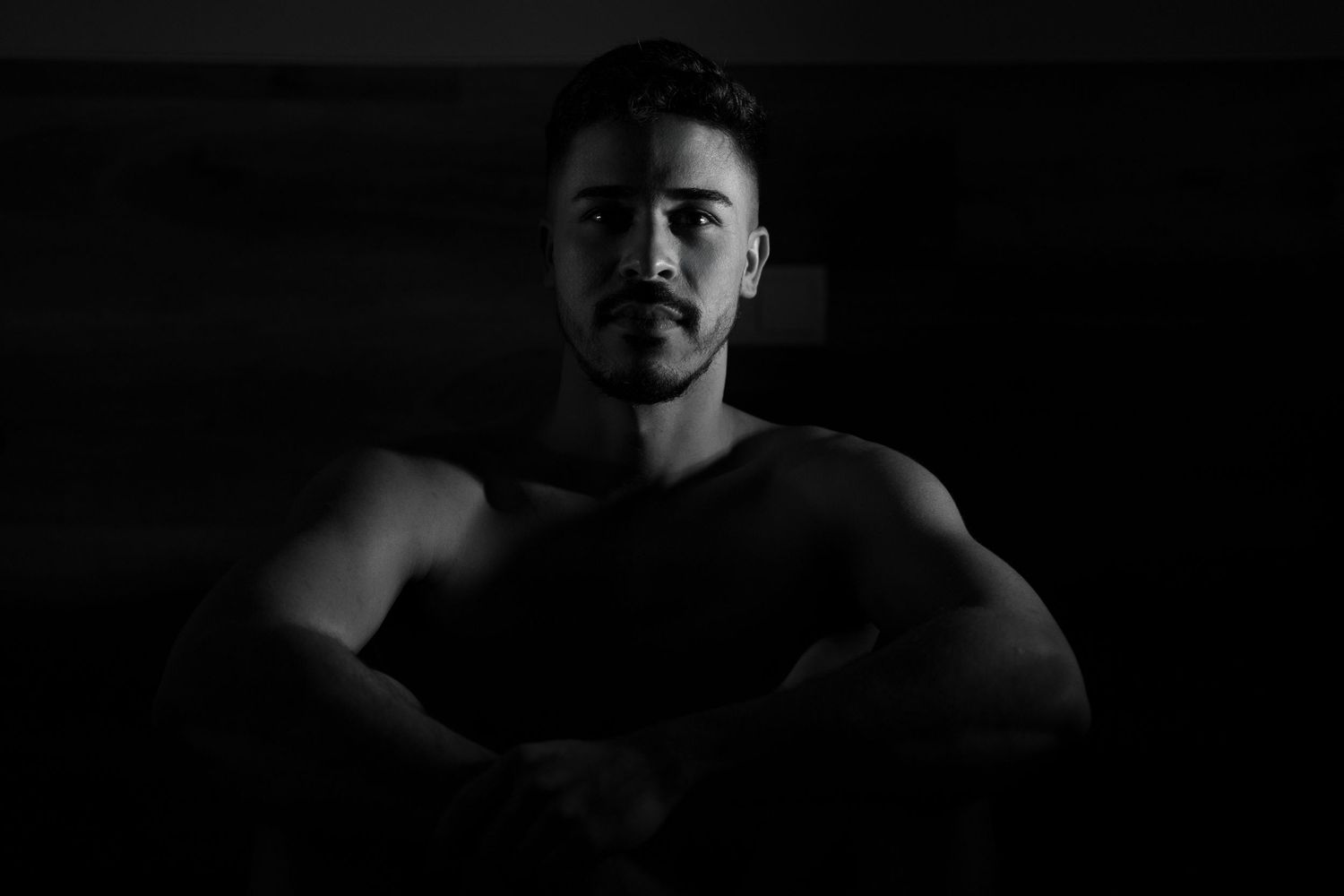 Dark and moody portrait photography with dramatic shadows.