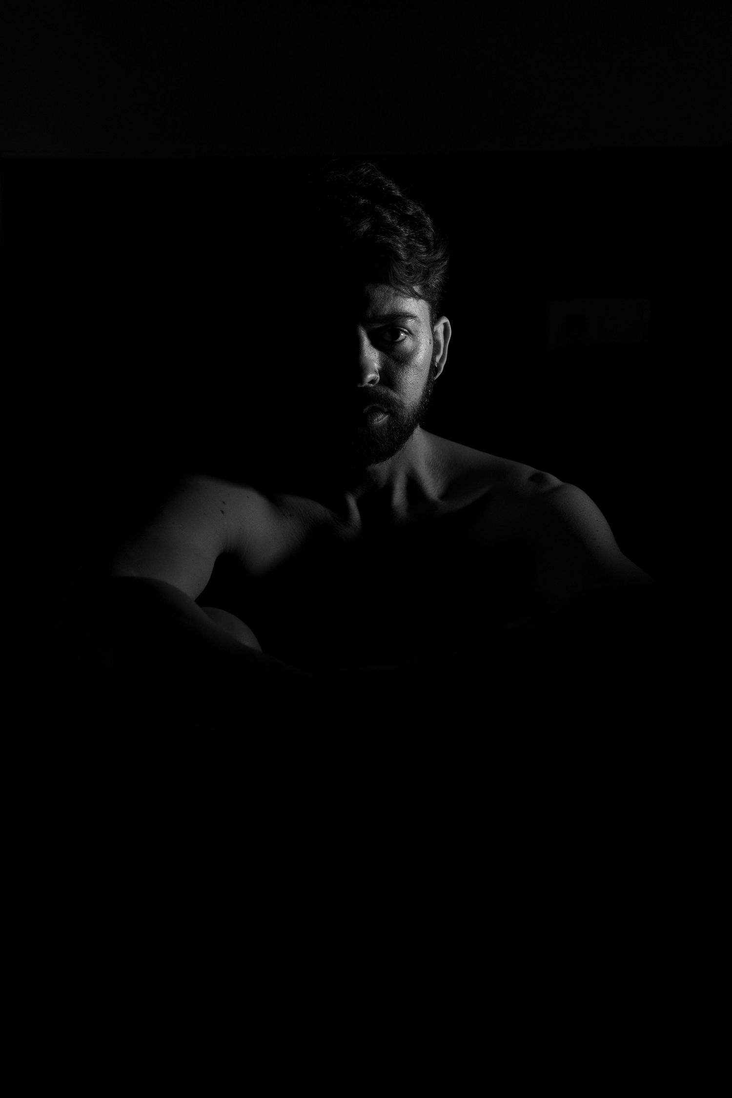 Low key portrait series with deep shadows and minimal lighting.
