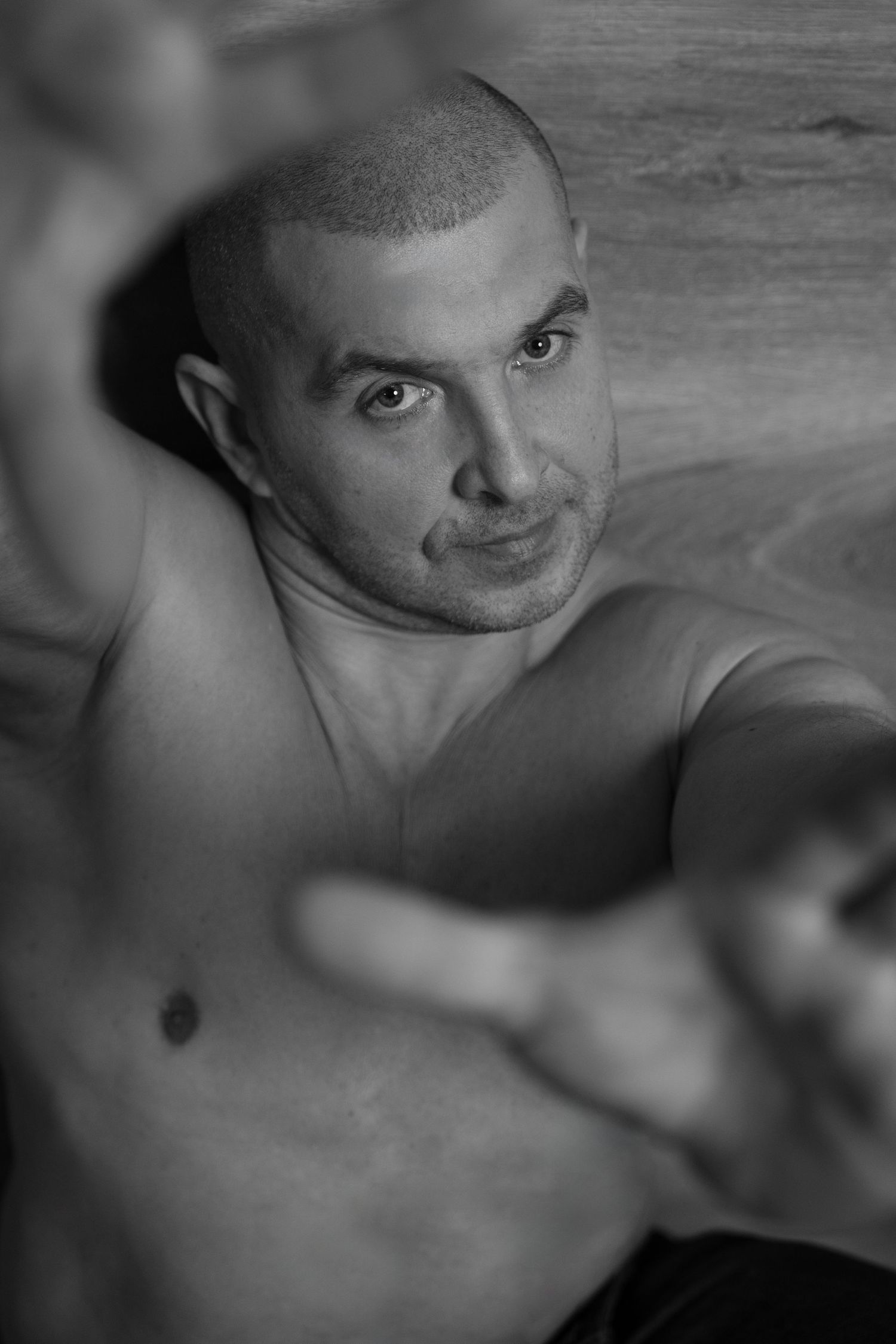 Moody black and white portrait with dramatic side lighting.
