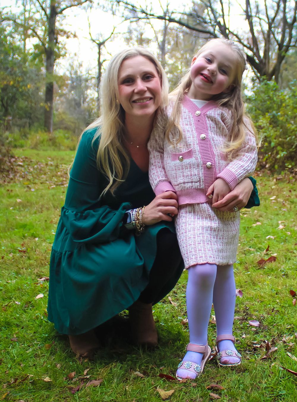 Mother and daughter sharing playful moment together outdoors in autumn setting.