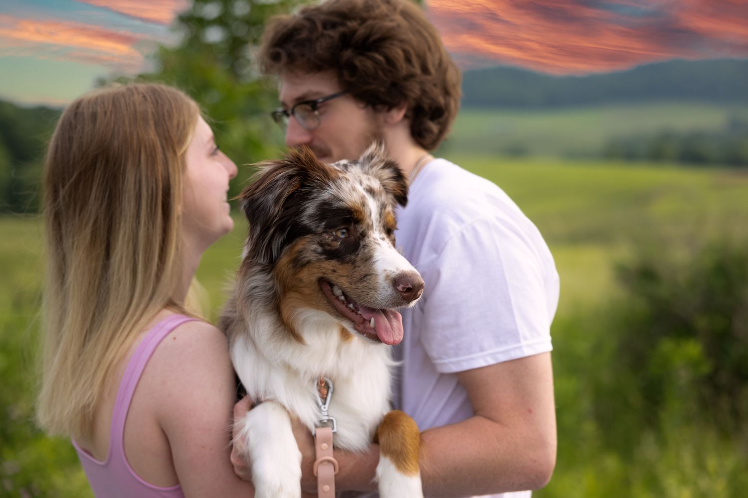 Couple standing together holding cute dog cute couple pose west virignia