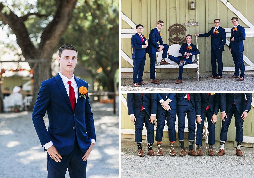 Wedding party members in navy suits pose for fun photos showing off their colorful socks and dress shoes.