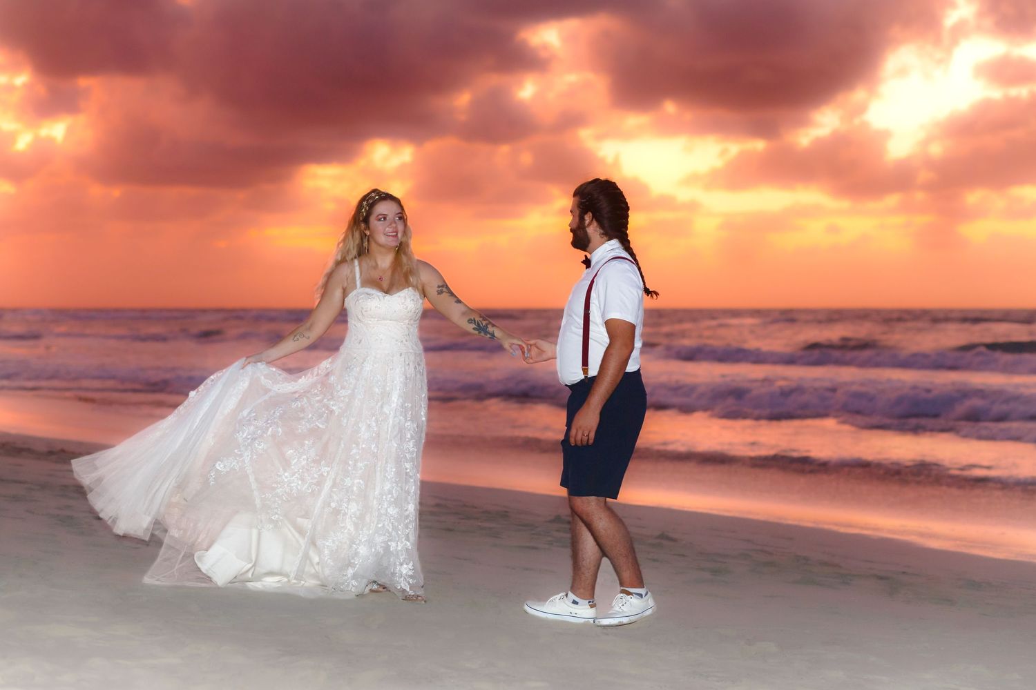 Wedding couple walking on the beach during sunset.