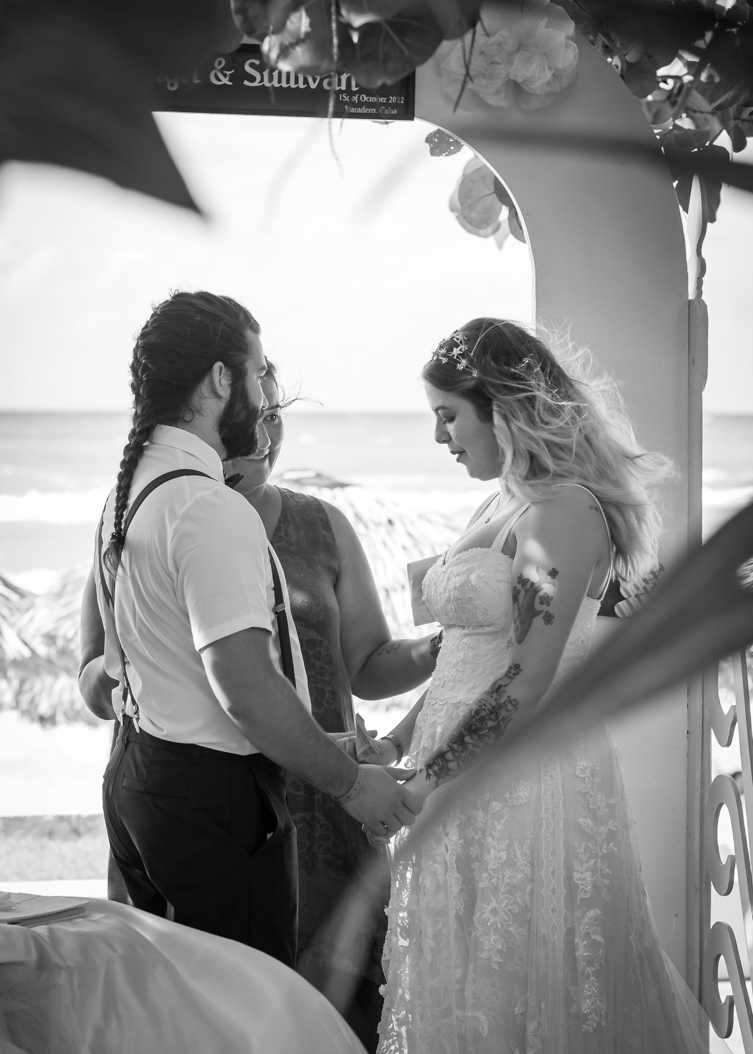 Wedding couple holding each others hands.