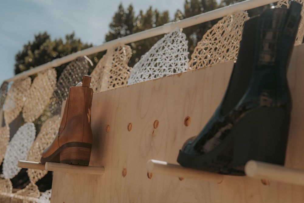Rustic wooden benches and decorative elements arranged outdoors for a wedding ceremony setting.