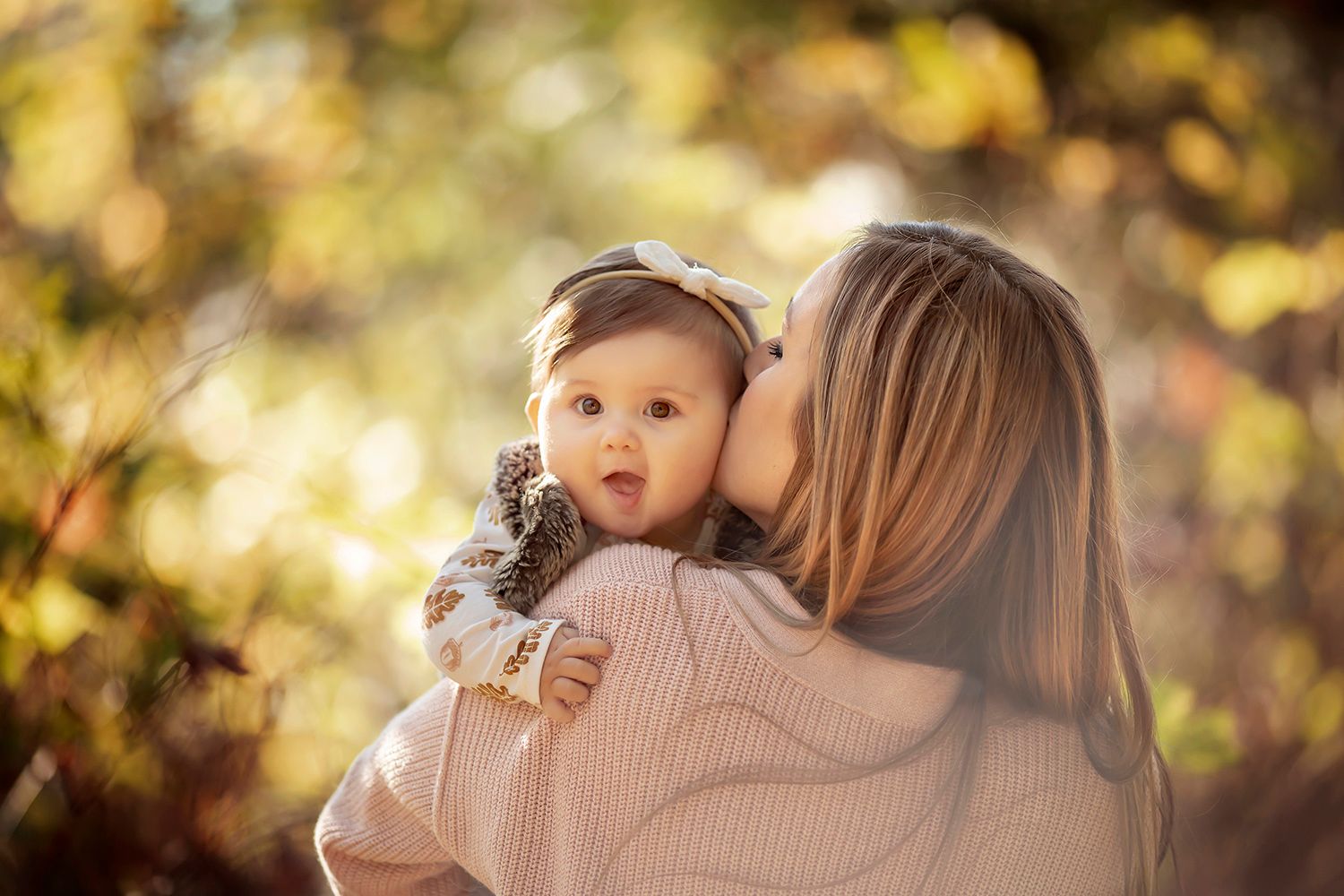 Mom kissing her baby girl on the cheek outdoors. Vancouver family photos