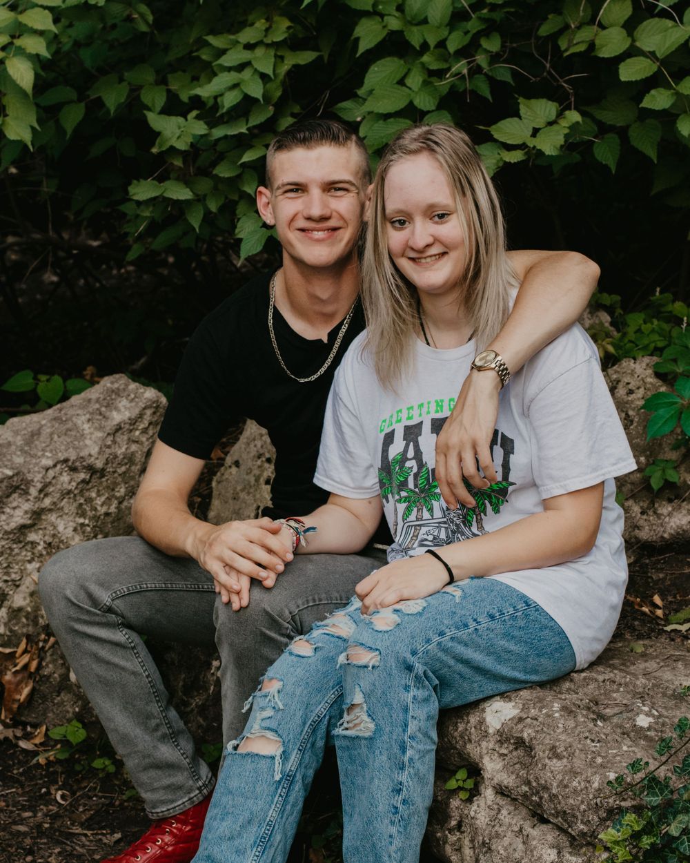 A young couple poses together during the boy's senior photos