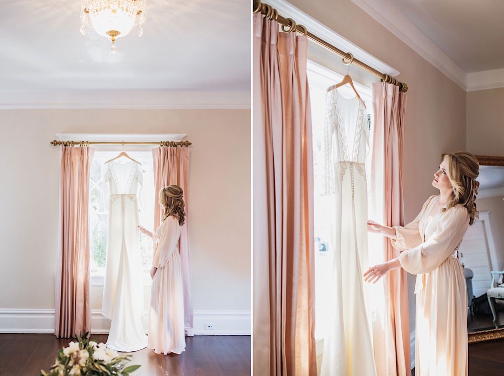 Bride in a silk robe looking at her wedding dress