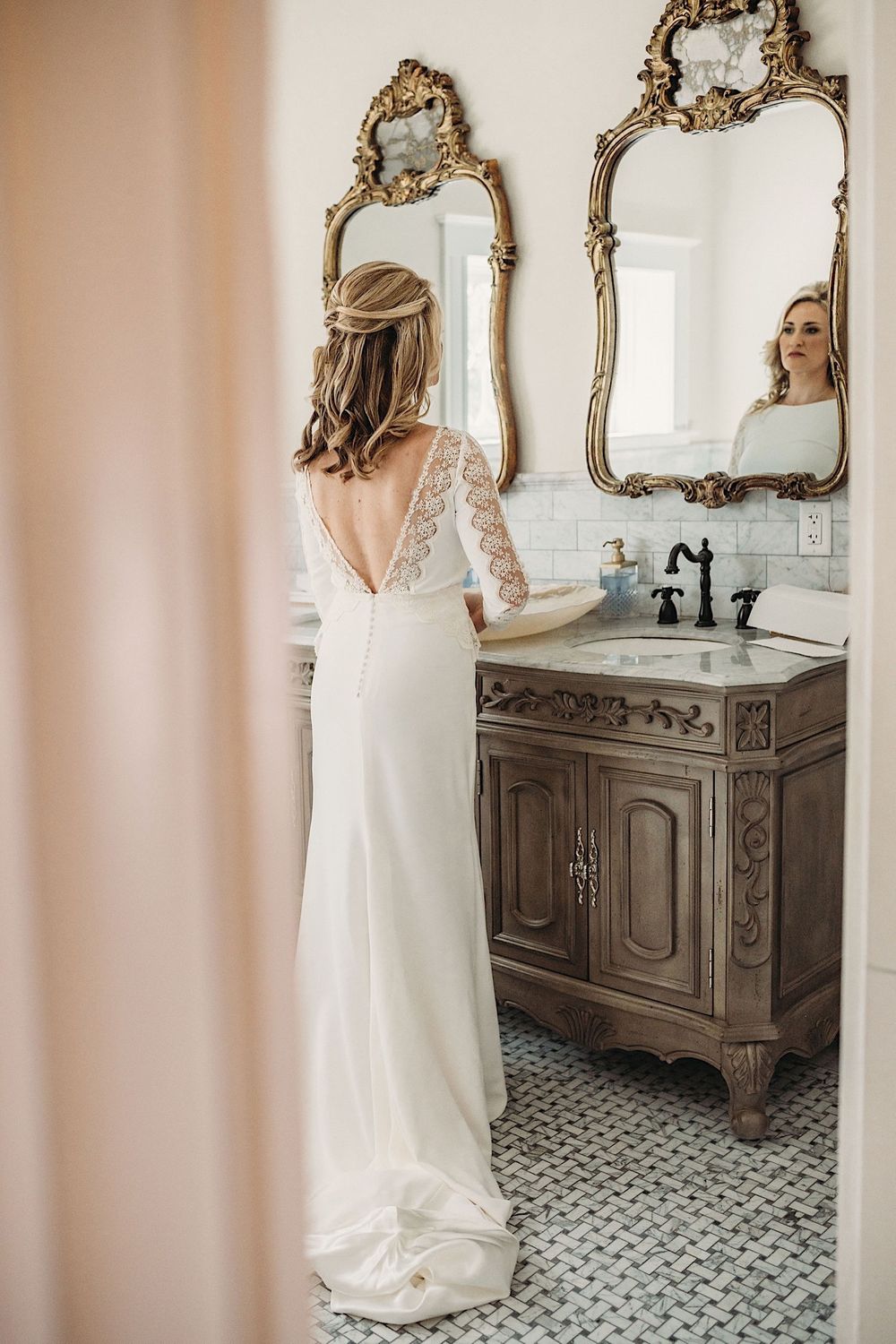 bride looking in the mirror in the bathroom of the Orlo in tampa