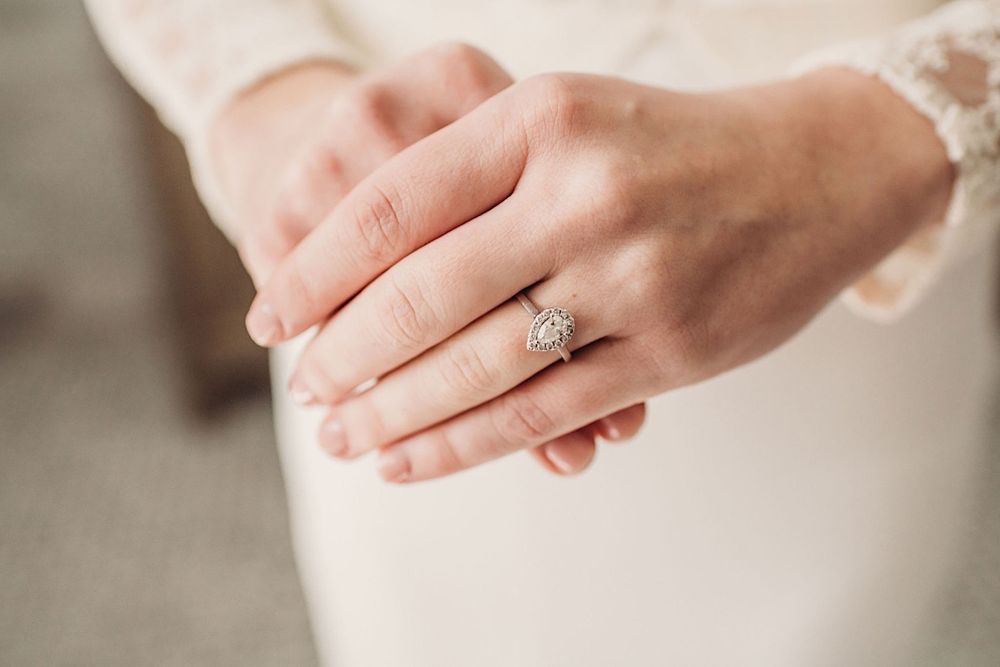 Close up of the bride's hands showing her engagement ring