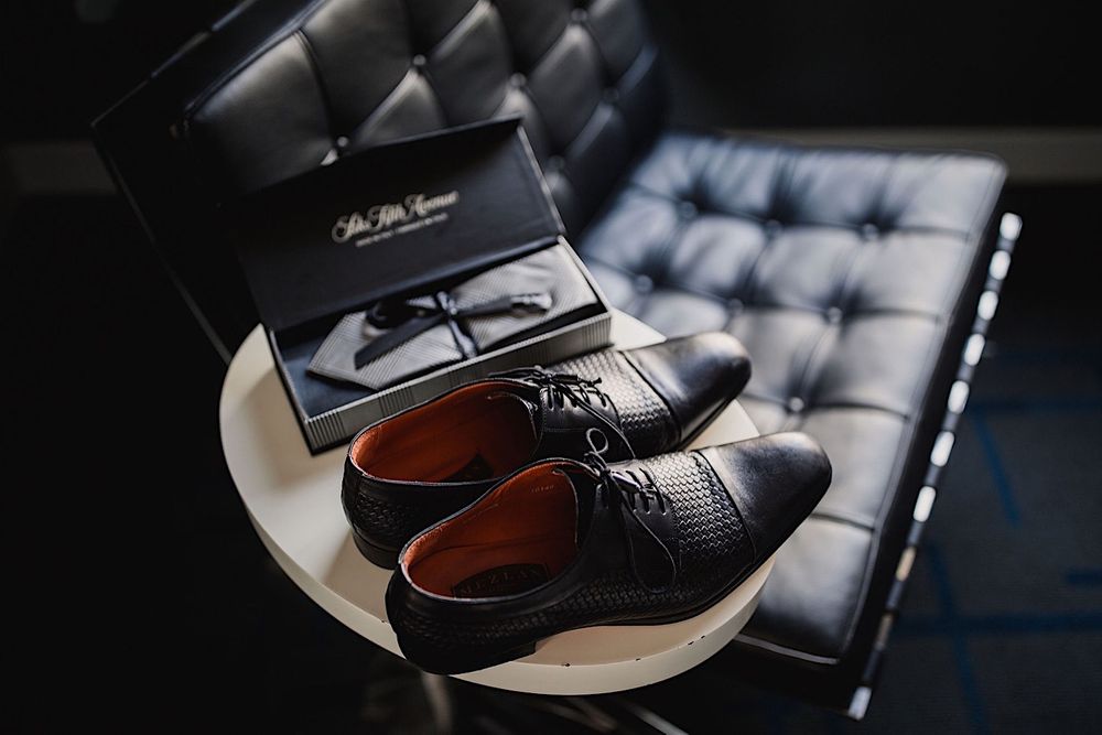 Groom's wedding shoes sitting on a table