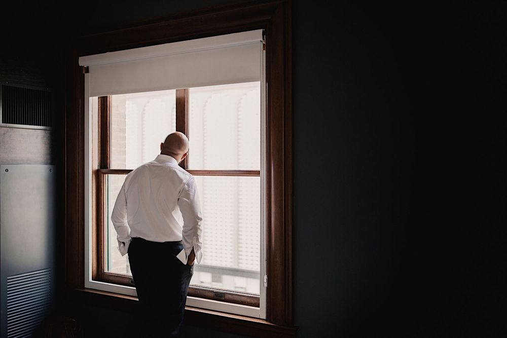 The back of the groom looking out the window