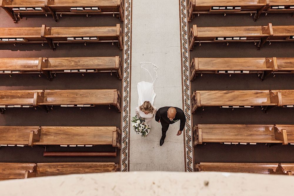 the bride and groom walking down the aisle at their wedding photographed from above