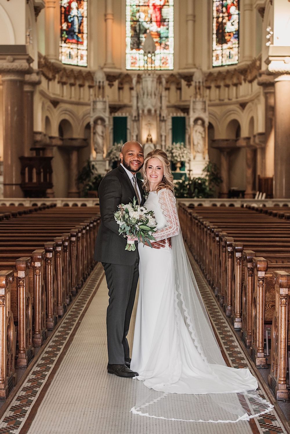 bride and groom looking at the camera and smiling