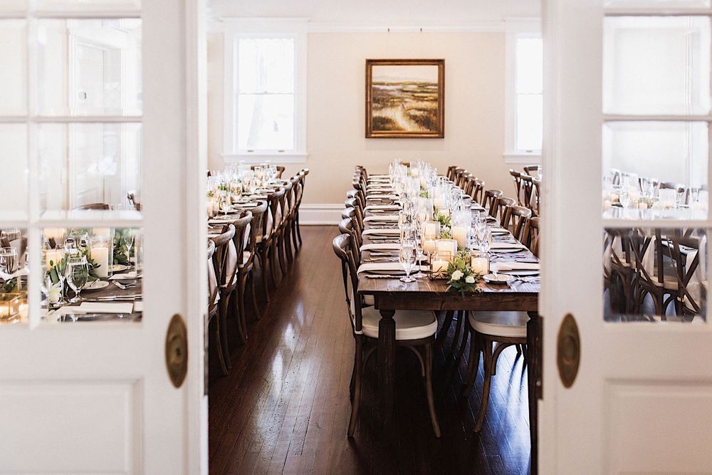 a view of tables decorated with candles and greenery