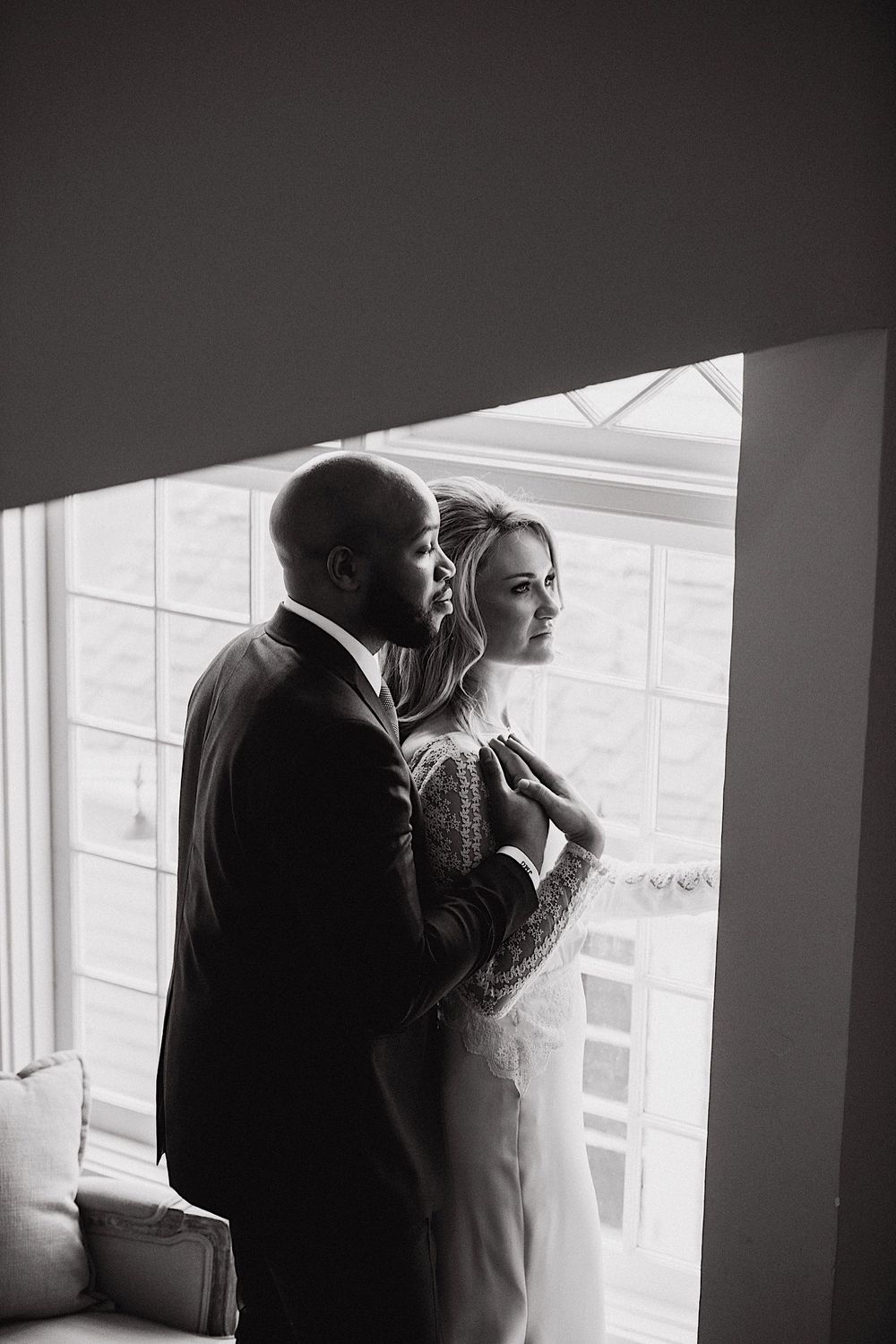 bride and groom looking out the window together