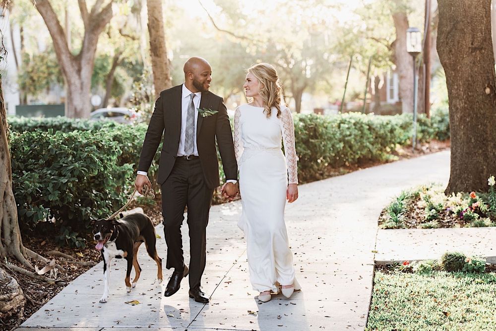 bride and groom walking their dog