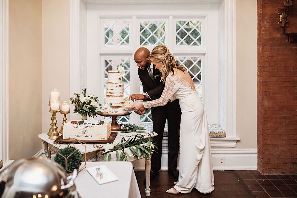 bride and groom cutting their wedding cake