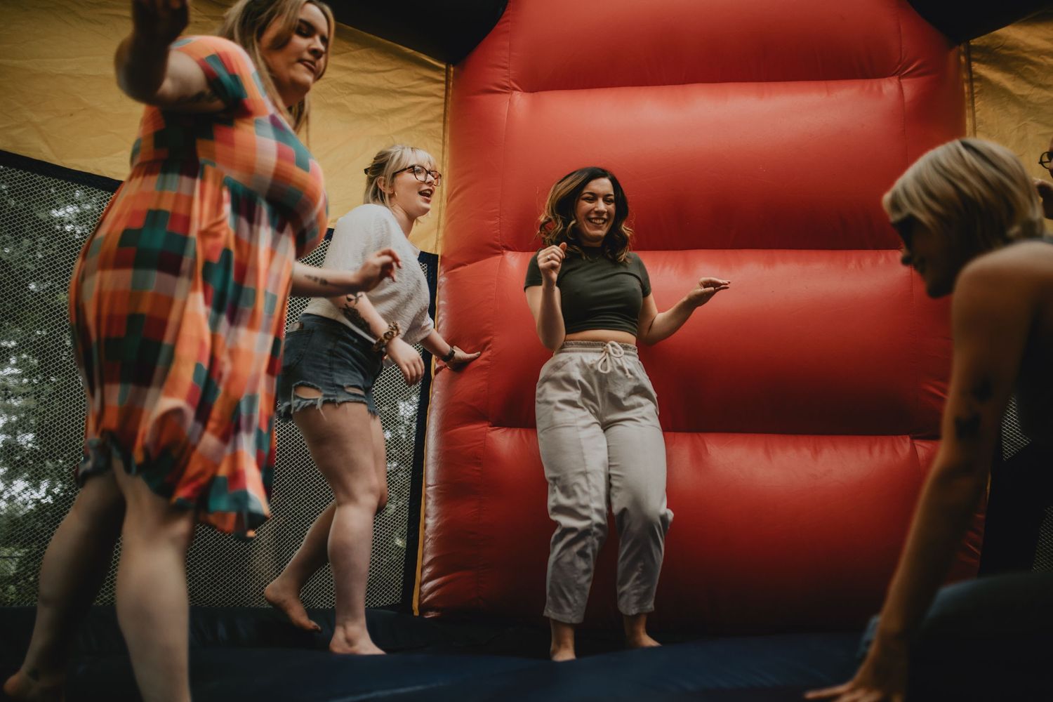 a group of friends bouncing in a bounce house