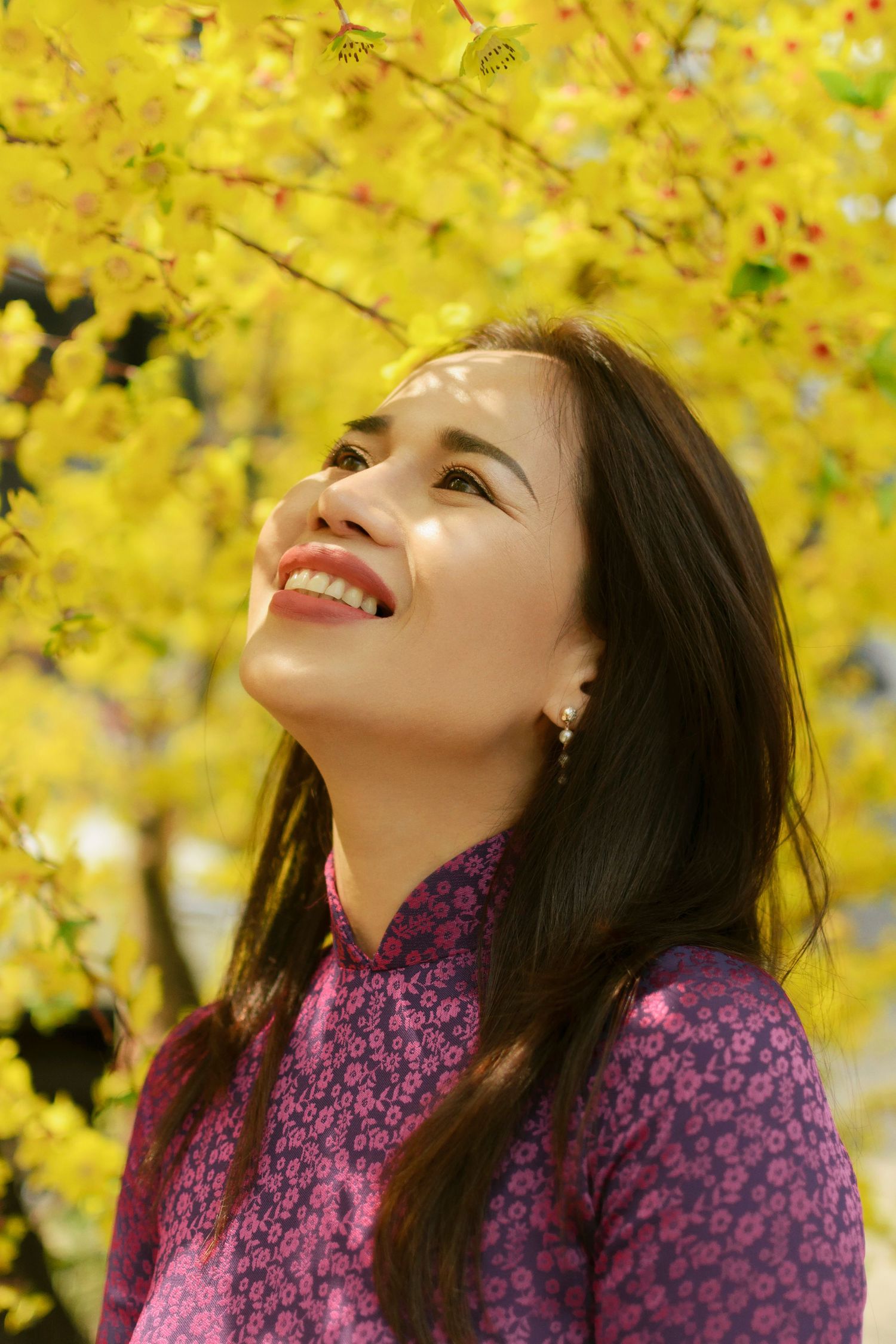 Tet photoshoot under yellow apricot blossoms in Thanh Nien Cultural House by photographer Anastasia Sokyrka in Saigon