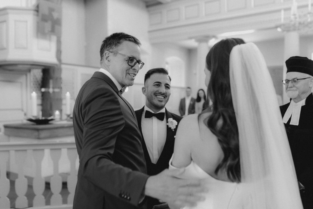 An emotional wedding ceremony moment captured in black and white photography.