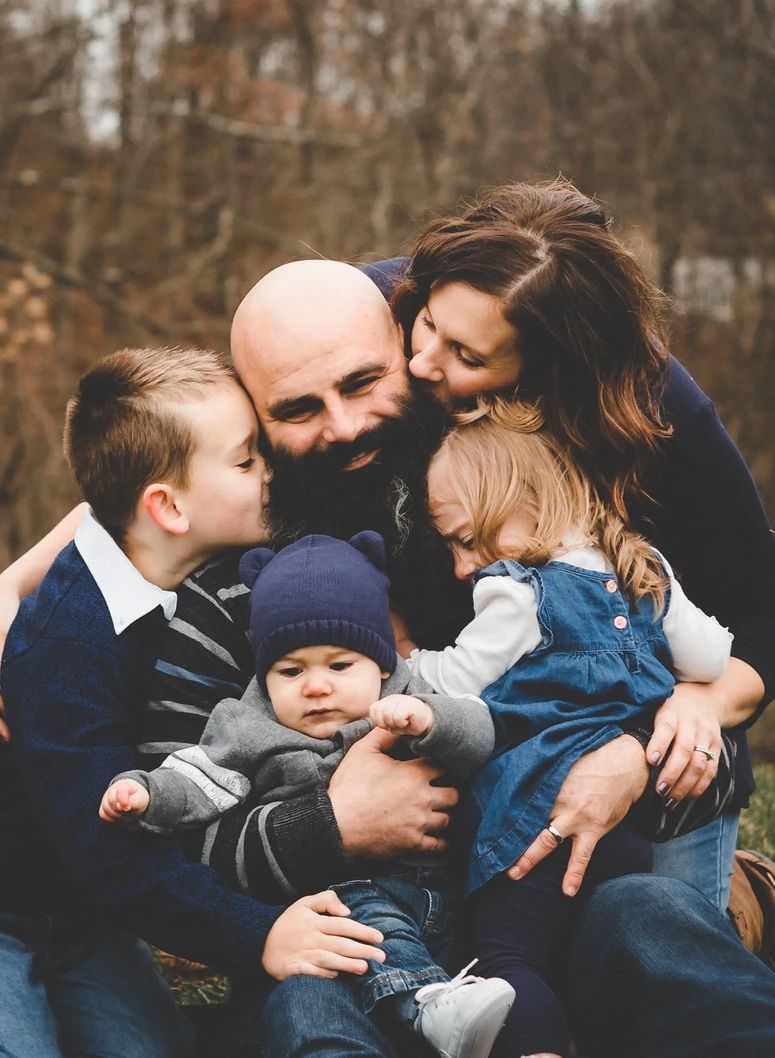 An intimate family moment captured outdoors during fall showing love and togetherness.