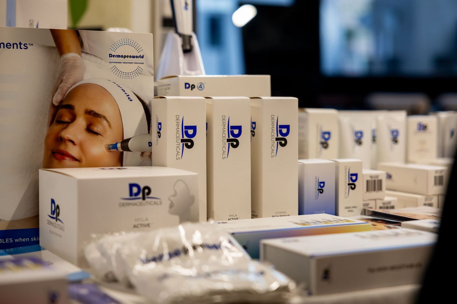 Beauty and cosmetic skincare products lined up in a row showing white packaging with blue Dr branding.