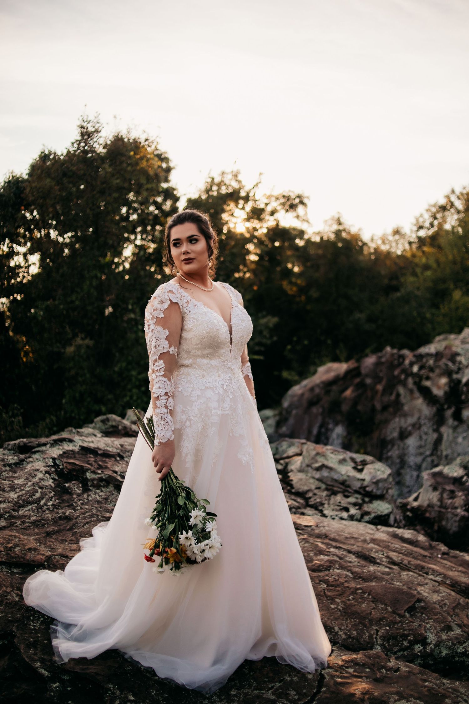 bride standing on rocks