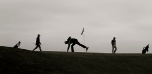 Black and white silhouettes of people golfing on a hilltop.