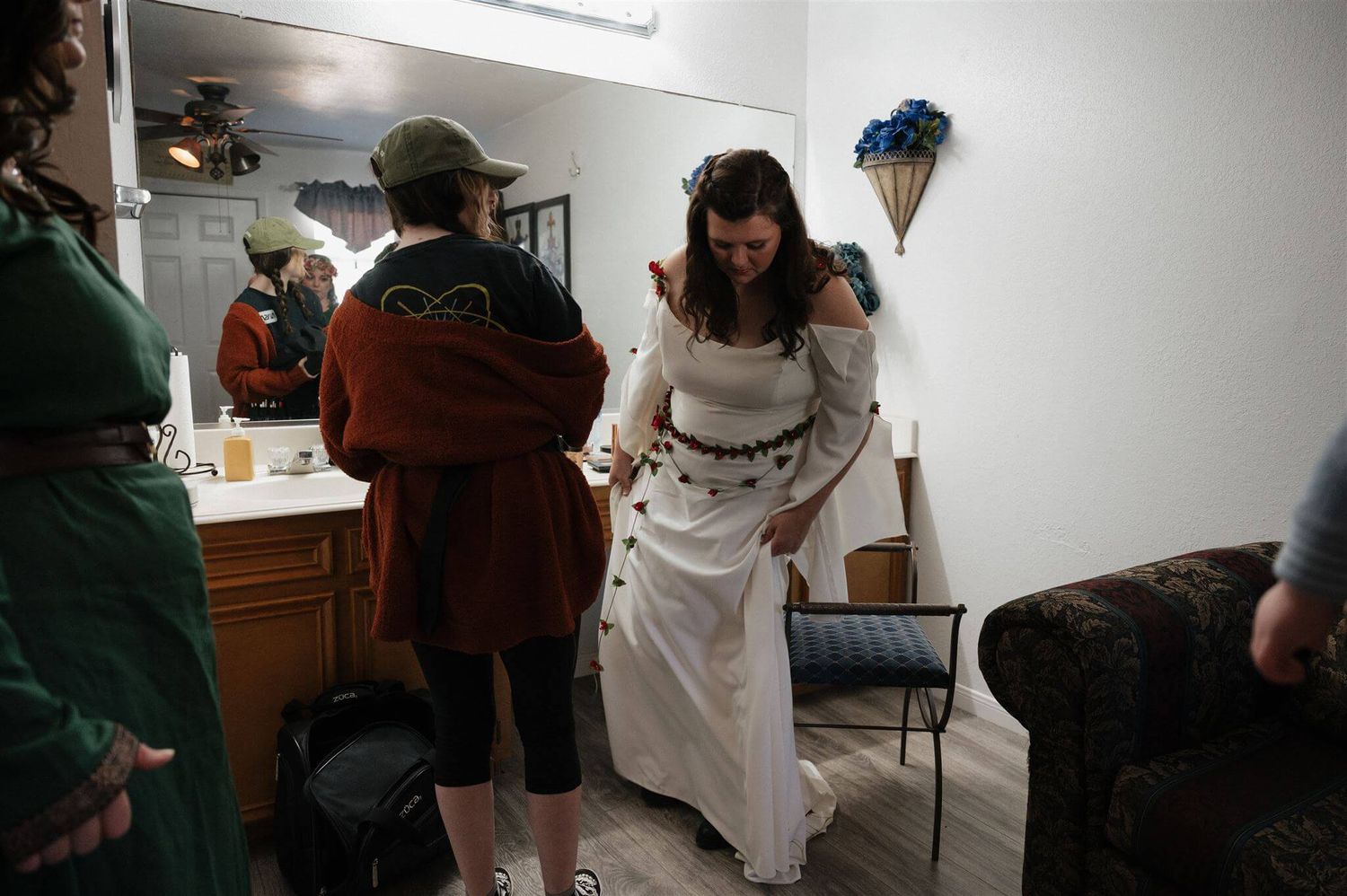 Behind the scenes preparation with period costumes in a dressing room.