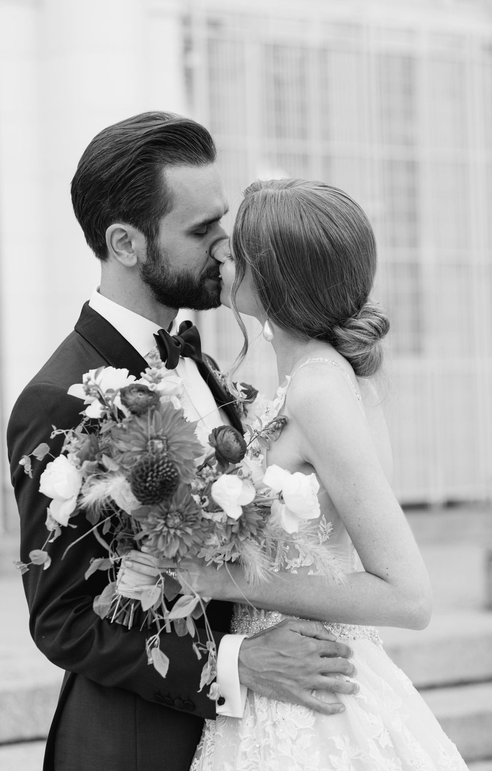 A romantic black and white portrait with a beautiful floral bouquet.