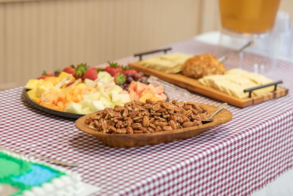 Dessert spread on a red and white checkered tablecloth with golf-themed decorations.