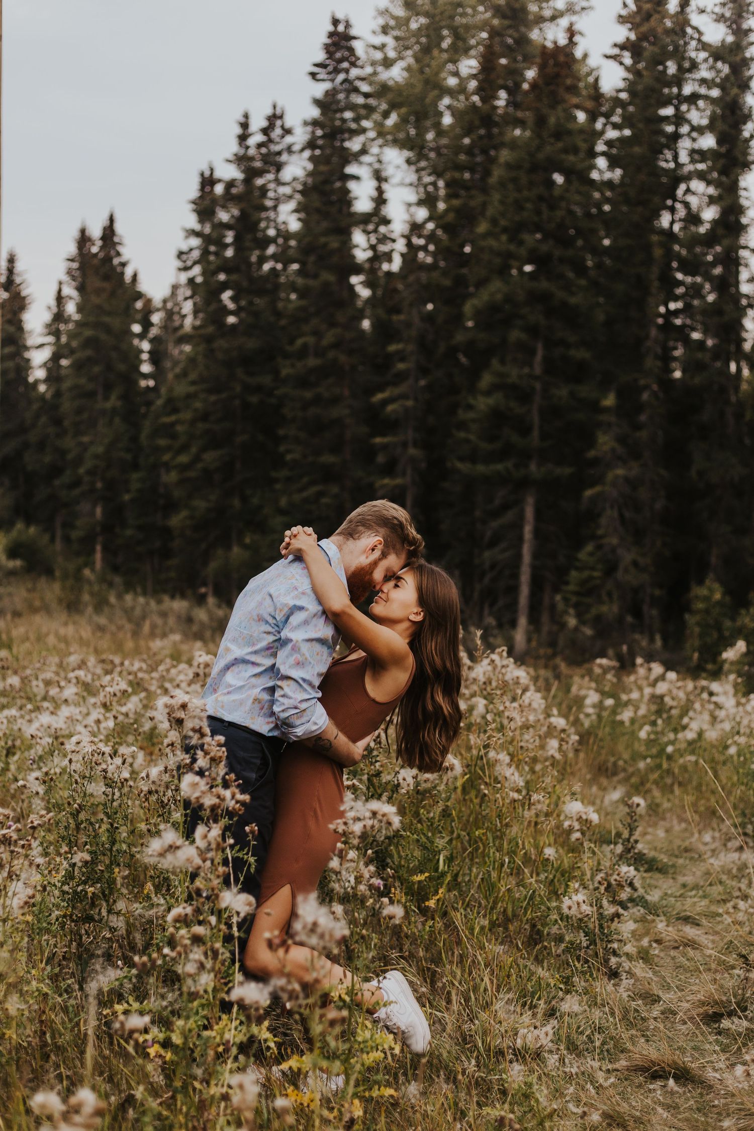 Couple embraces in field