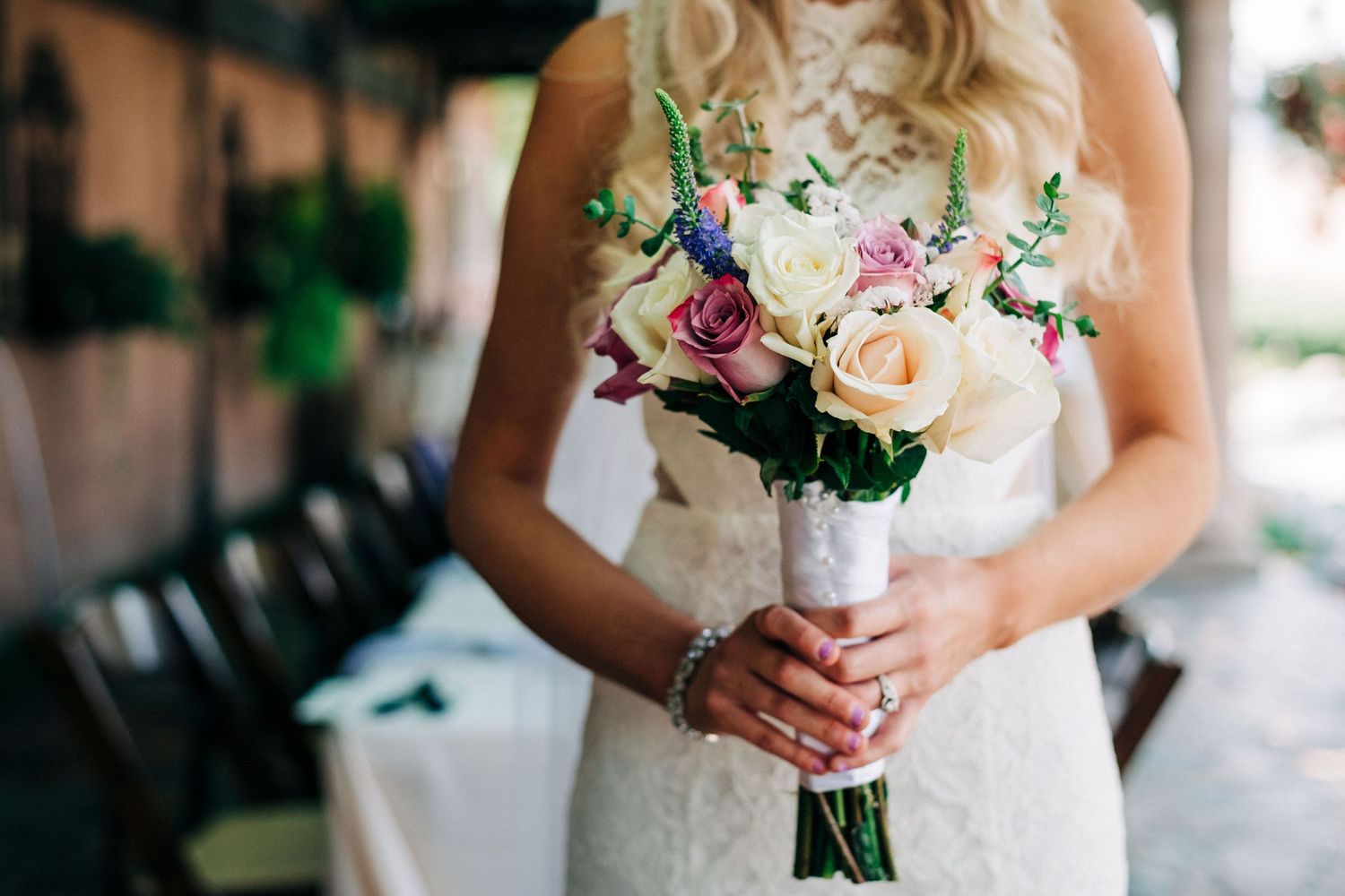 Bride holding bouquet of flowers at Tsillan Cellars outdoor wedding venue