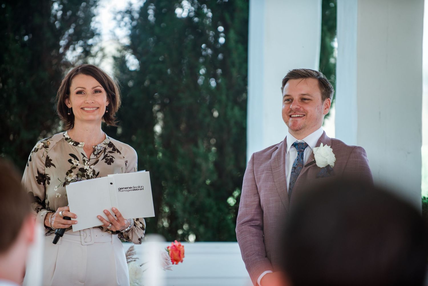 Ceremony participants sharing a moment during outdoor wedding event.
