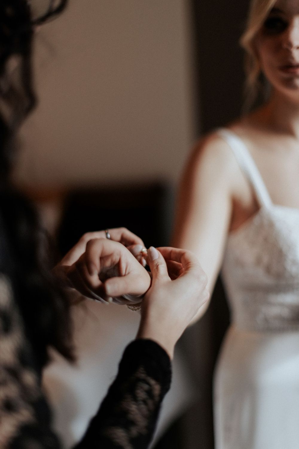 Hands holding during an intimate getting-ready moment before the wedding ceremony.