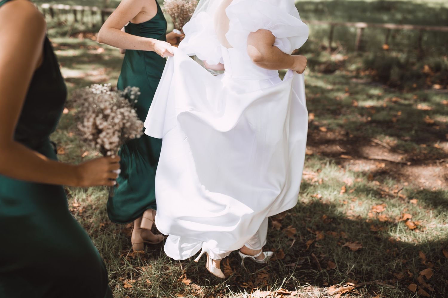 Intimate outdoor engagement photo session with couple in white outfits against natural backdrop.