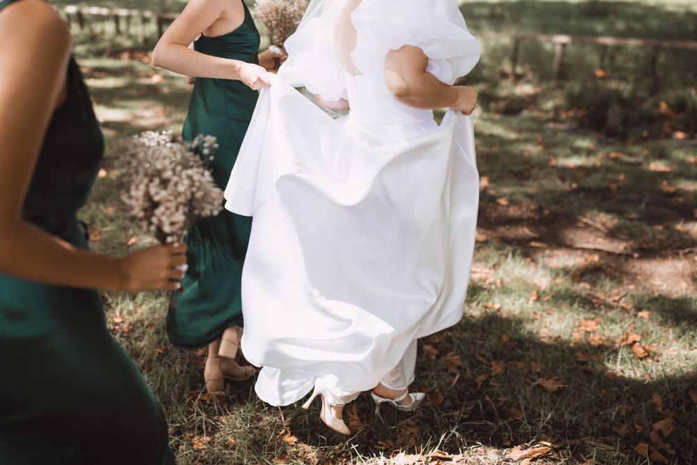 Intimate outdoor engagement photo session with couple in white outfits against natural backdrop.