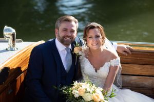 bride and groom on a boat on a sunny day
