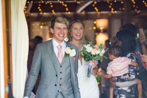 happy couple leaving their wedding