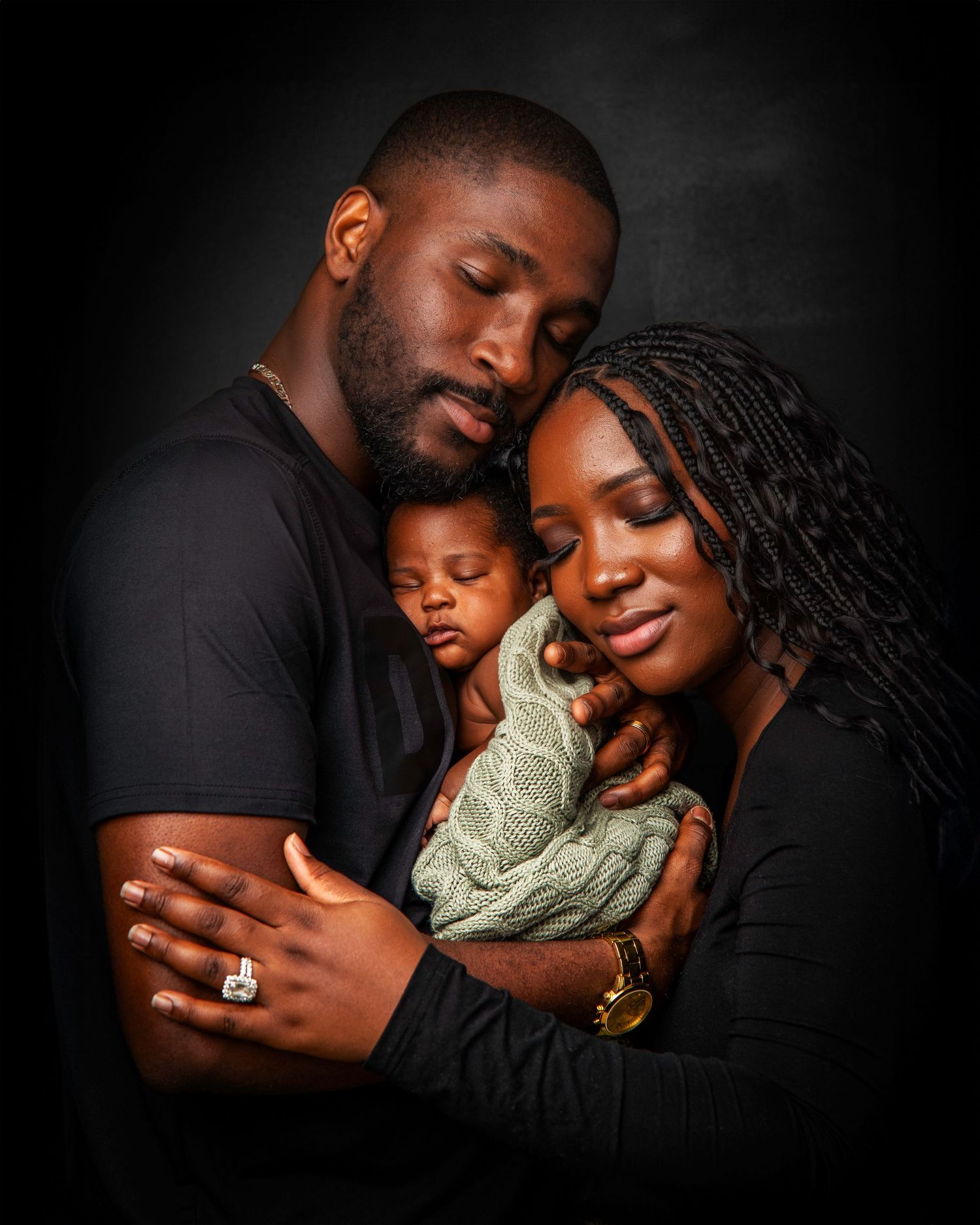 Family embracing in intimate black and white portrait series.