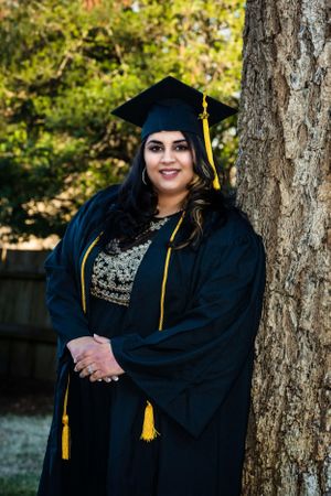 Graduation photo series showing graduate in traditional cap and gown posed by trees.