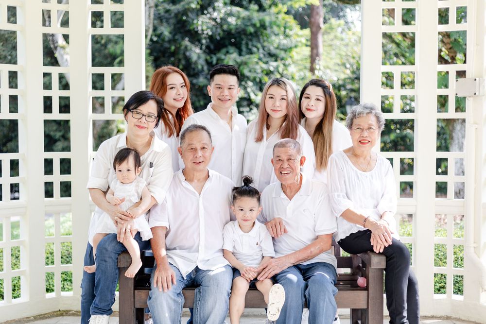 happy extended family photo taken at the bandstand in singapore botanic garden