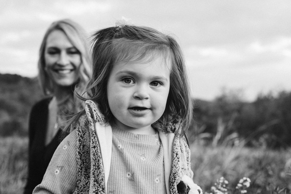 Black and white lifestyle portrait of mom and child outdoors by Abby Gleason Photography