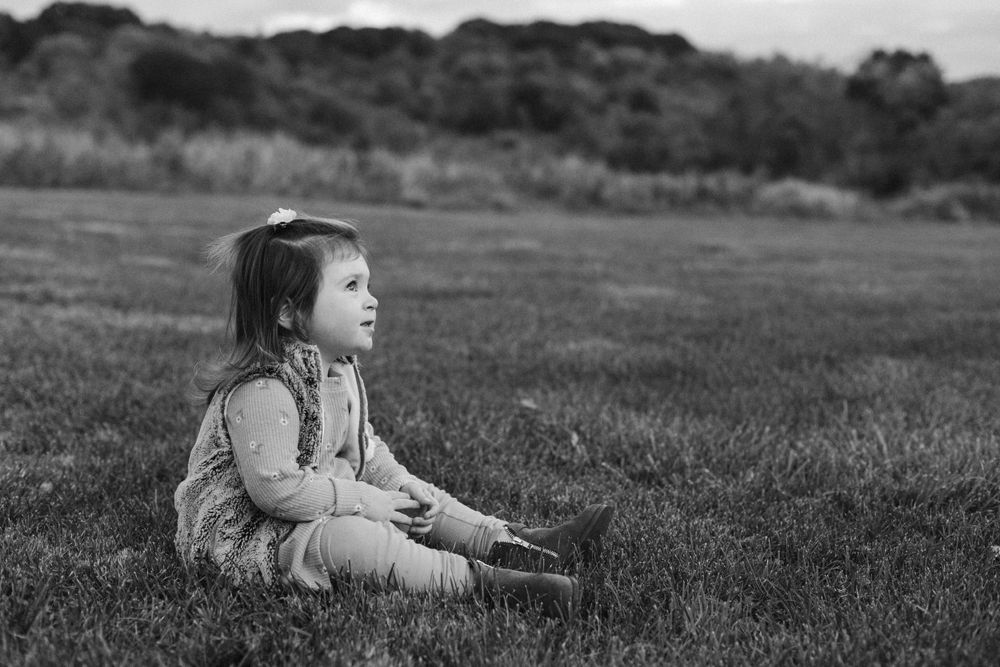 Fine art black and white portrait of a child in a field in Pittsburgh by Abby Gleason Photography