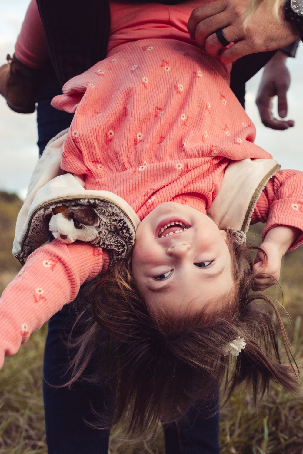 Fun and silly picture of little girl hanging upside down in family photo session  by Abby Gleason Photography