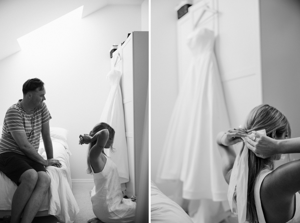 The bride puts on a giant white bow on the morning of her rustic wedding